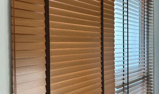 A room with wooden blinds and a window.