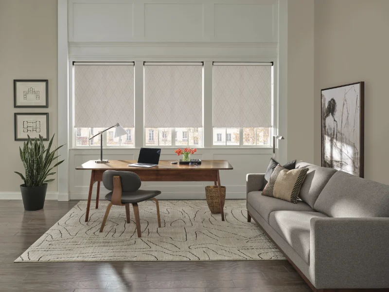 Hunter Douglas shades covering three picture windows.