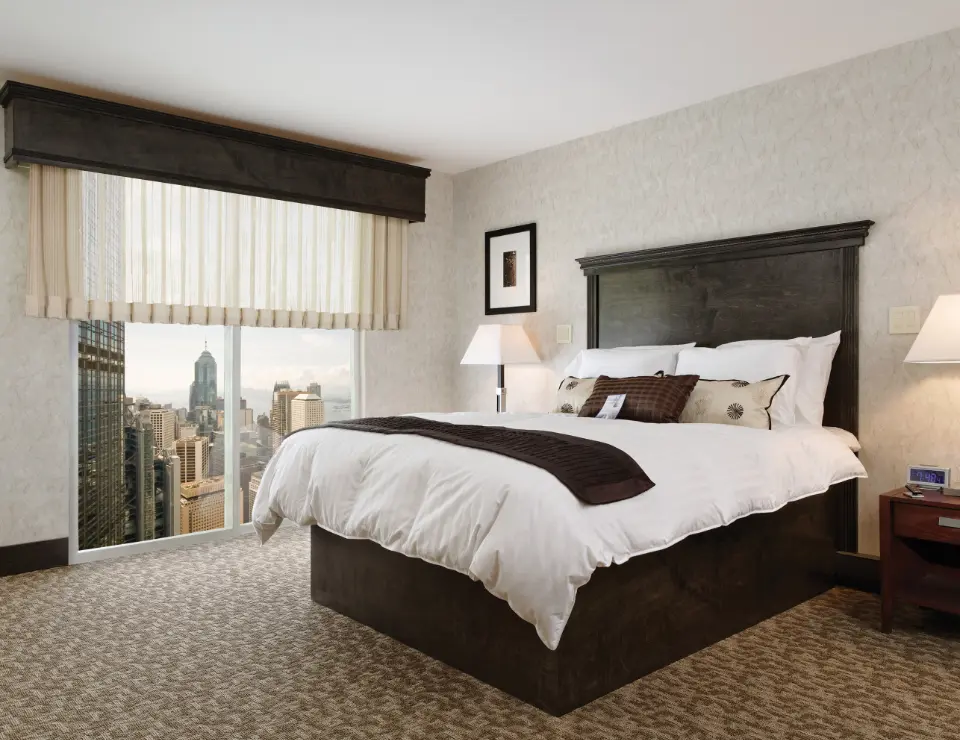 A hotel room with motorized curtains