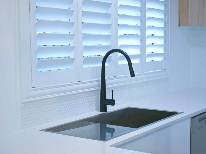 White plantation shutters in a kitchen.