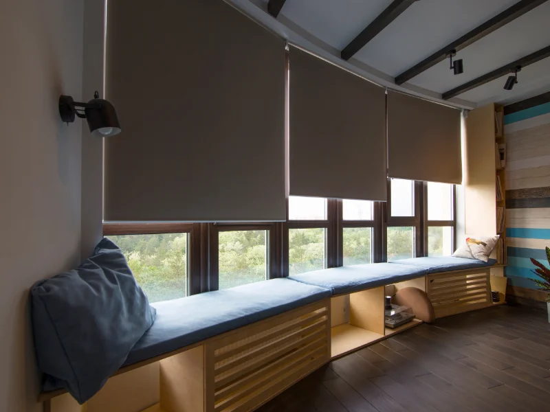 Blackout shades covering wide windows.