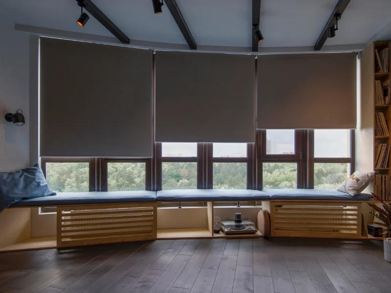 Blackout shades providing total coverage of wide windows.