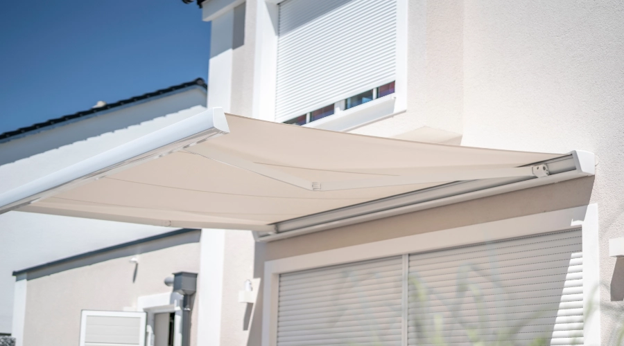 A white awning in back of a house