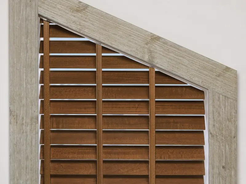 Wooden blinds on a irregularly shaped window.