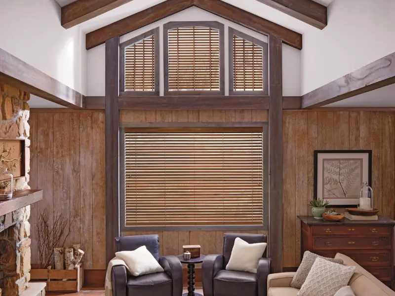 Wooden blinds covering a large living room window.