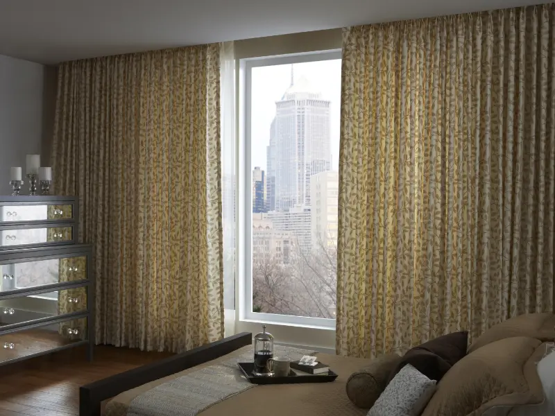 Floor-length drapes in a bedroom.