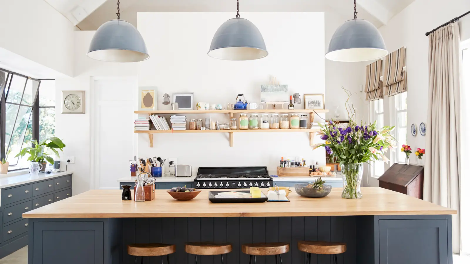 A modern kitchen with Roman shades