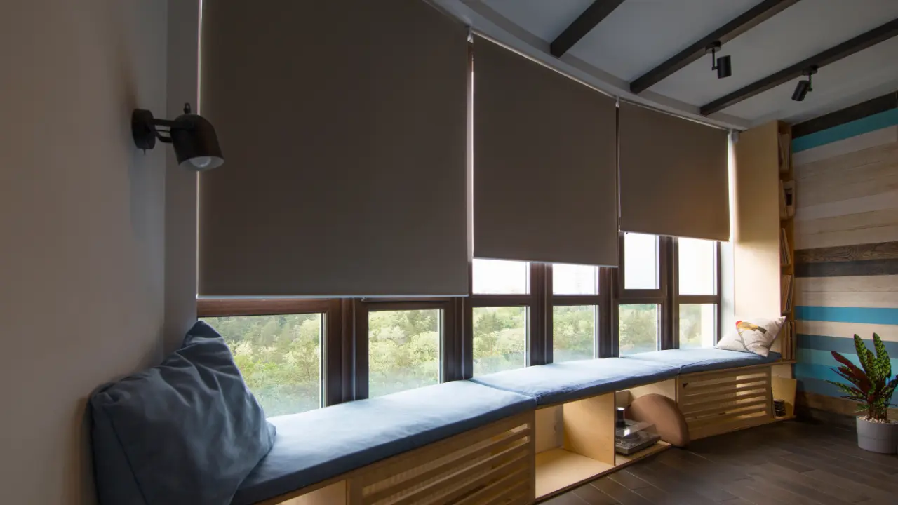 A room with a window seat and motorized roller shades