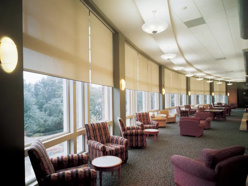 Motorized shades in the lounge of a commercial building.