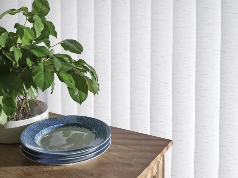 White vertical blinds with narrow slats.