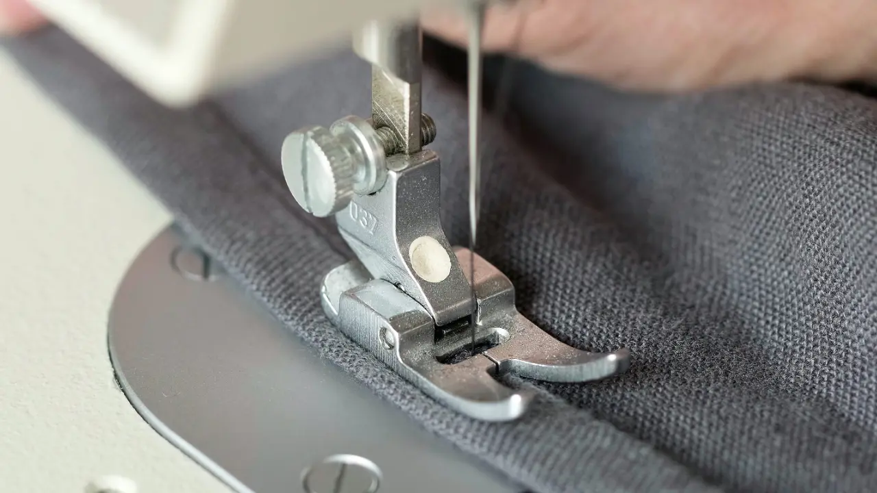 A curtain maker sewing fabric