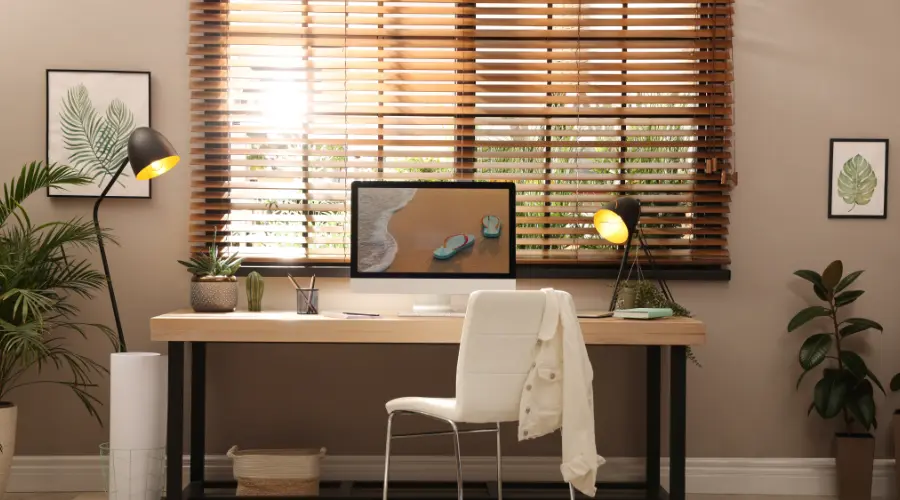 A home office with wooden blinds