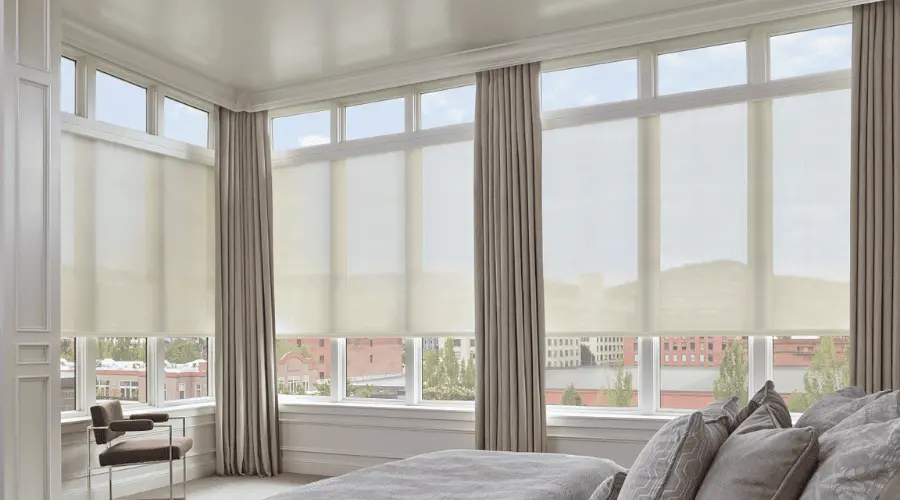 Bright bedroom with solar shades on tall windows